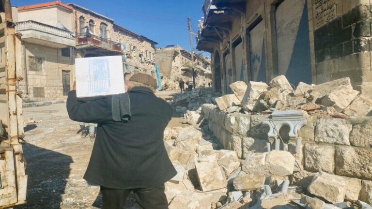 A man carries home WFP food rations in Syrias quake hit Idlib Governorate. WFP Lina Alqassab 1